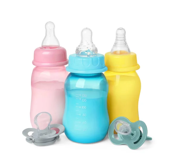 stock image Feeding bottles with milk and pacifiers on white background