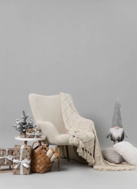 Stylish photo zone with armchair and Christmas decor in professional studio