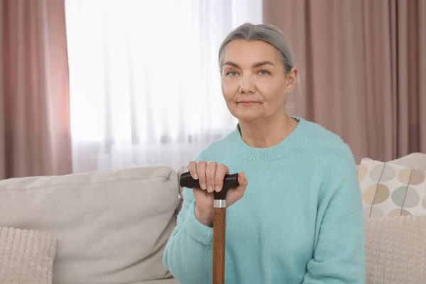 Senior Woman Walking Cane Sitting Sofa Home Space Text — Stock Photo, Image