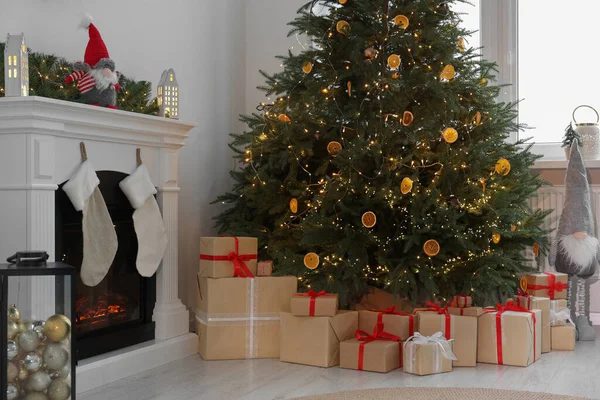 クリスマスツリーとリビングルームのお祝いの装飾の下で多くの異なるギフトボックス — ストック写真