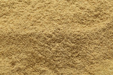 Aromatic mustard powder as background, top view
