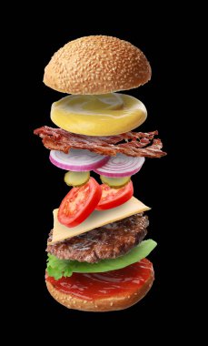 Siyah arka planda farklı uçuş malzemeleri olan lezzetli bir burger.