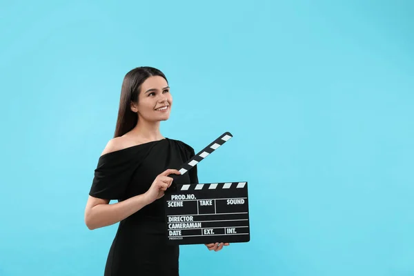 Happy Actress Clapperboard Light Blue Background Space Text Film Industry — Stock Photo, Image