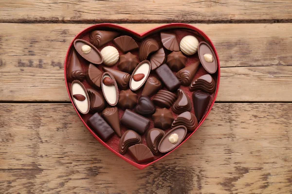 Hjärtformad Låda Med Läckra Chokladgodis Träbord Ovanifrån — Stockfoto