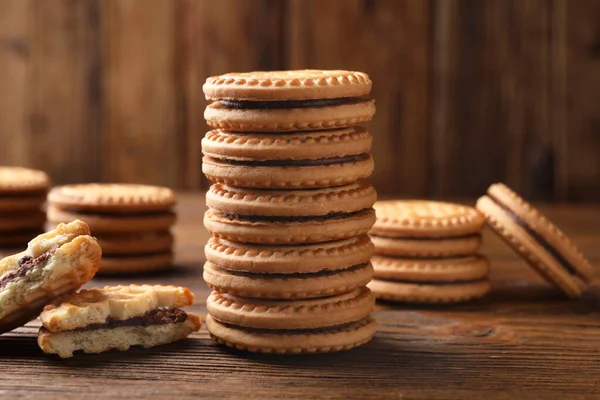 stock image Tasty sandwich cookies with cream on wooden table, closeup