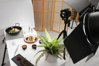 Professional equipment and composition with delicious meat medallion on white table in studio. Food photography