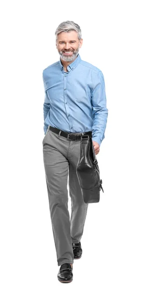 Mature businessman in stylish clothes with briefcase walking on white background