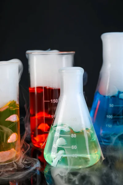 Laboratory Glassware Colorful Liquids Steam Black Background Chemical Reaction — Stock Photo, Image