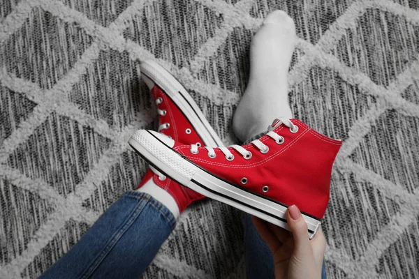 Woman New Stylish Red Sneakers Sitting Carpet Top View — Stock Photo, Image