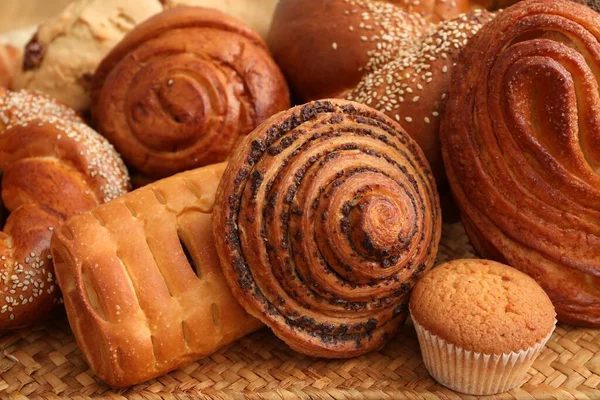 Different Tasty Freshly Baked Pastries Wicker Mat Closeup — Stock Photo, Image