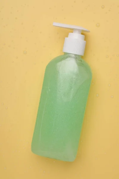 Wet Bottle Face Cleansing Product Pale Orange Background Top View — Stock Photo, Image