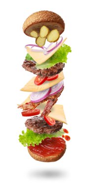 Beyaz arka planda farklı uçuş malzemeleri olan lezzetli bir burger.