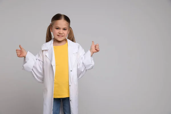 Маленькая Девочка Медицинской Форме Показывает Большие Пальцы Светло Сером Фоне — стоковое фото