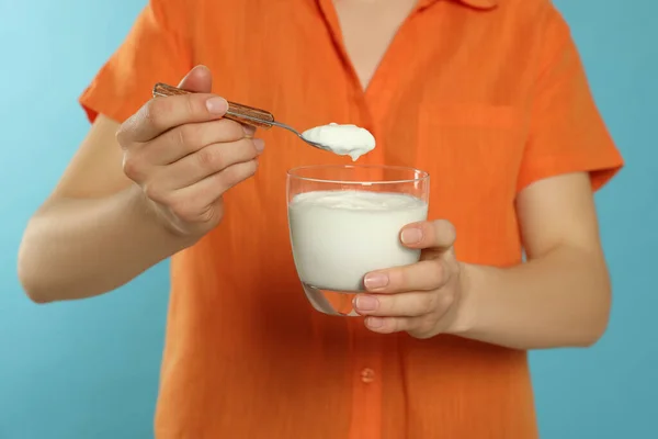 Primer Plano Mujer Con Sabroso Yogur Sobre Fondo Azul Claro — Foto de Stock