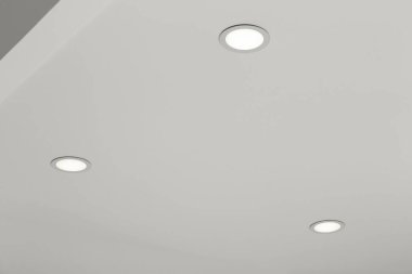 White ceiling with modern lighting in room, low angle view