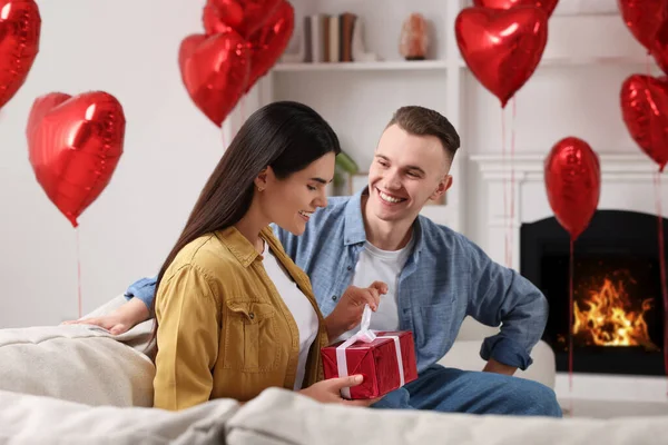 Woman Opening Gift Her Boyfriend Indoors Valentine Day Celebration — Stockfoto