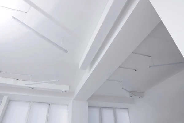 Ceiling with ventilation system and lights in room, low angle view