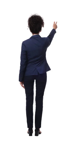 stock image Businesswoman in suit pointing at something on white background, back view