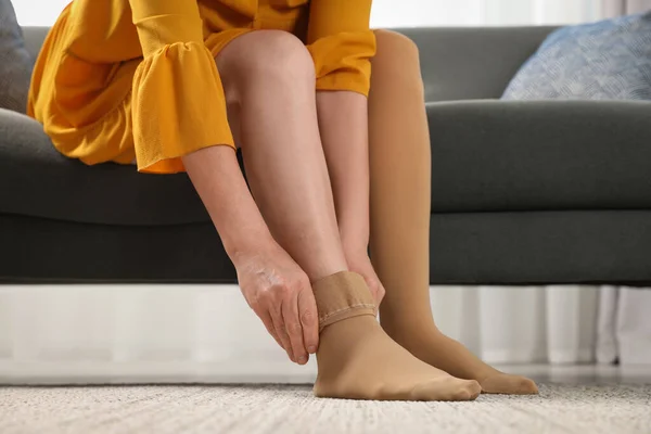 Woman Putting Compression Stocking Living Room Closeup Prevention Varicose Veins — Stock Photo, Image