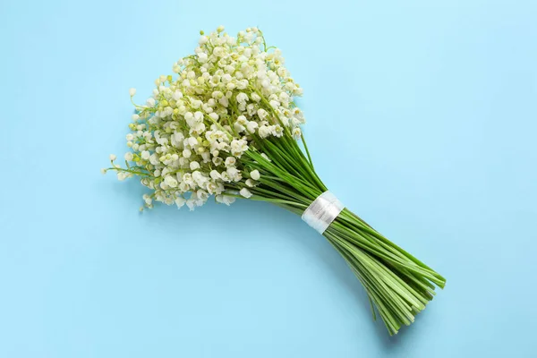 stock image Beautiful lily of the valley bouquet on light blue background, top view