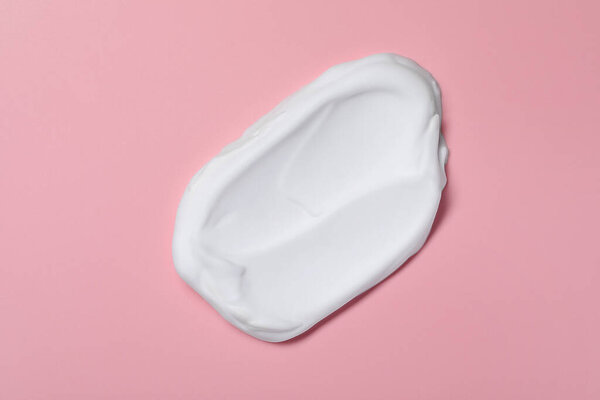 Sample of shaving foam on pink background, top view