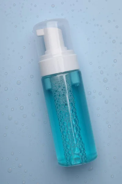 Wet Bottle Face Cleansing Product Light Blue Background Top View — Stock Photo, Image