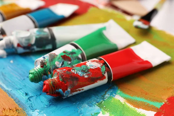 Tubos Tintas Óleo Coloridas Sobre Tela Com Pintura Abstrata Close — Fotografia de Stock