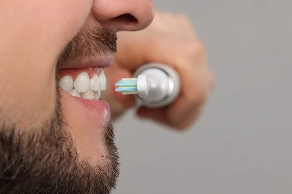 Man Brushing His Teeth Electric Toothbrush Light Grey Background Closeup — Stock Photo, Image
