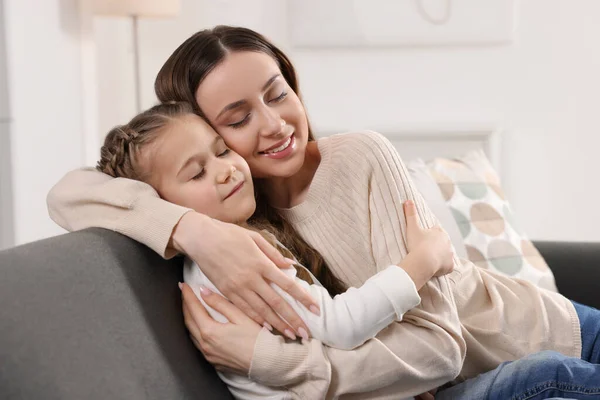 Happy Mother Hugging Her Cute Daughter Sofa Home — Stock Photo, Image