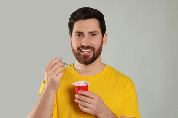 Handsome Man Delicious Yogurt Spoon Light Grey Background — Stock Photo, Image