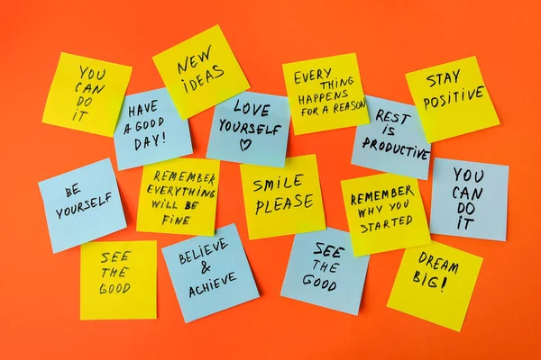 stock image Paper notes with life-affirming phrases on orange background