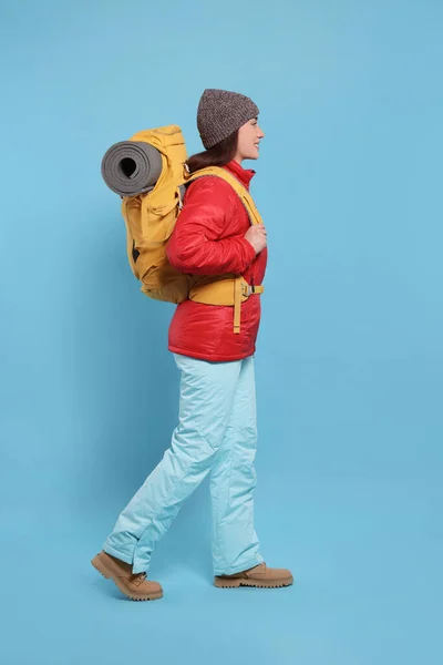 Uśmiechnięta Młoda Kobieta Plecakiem Chodząca Jasnoniebieskim Tle Turystyka Aktywna — Zdjęcie stockowe