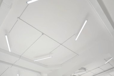 White ceiling with modern lighting in room, low angle view