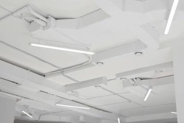 White ceiling with modern lighting in room, low angle view