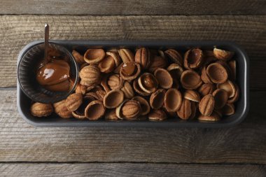 Ceviz şeklinde kurabiye yapıyorum. Pişmiş hamur ve karamelize edilmiş süt ahşap masa, üst görünüm