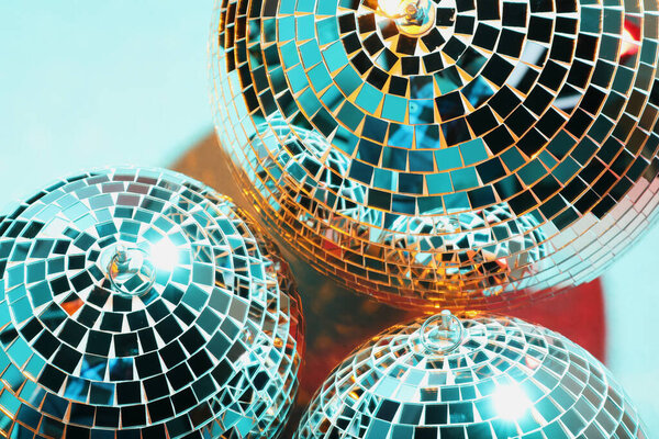 Bright shiny disco balls on color background, above view
