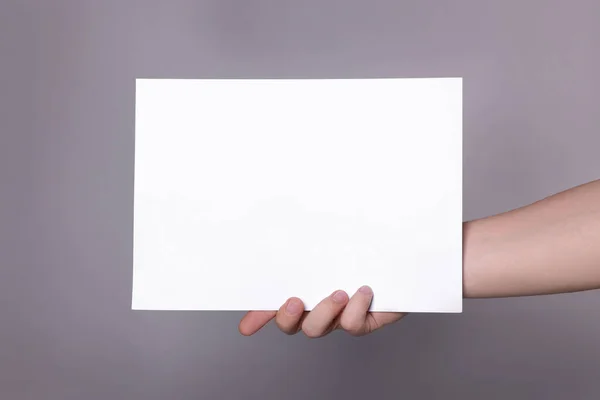 Woman Holding Sheet Paper Grey Background Closeup Mockup Design — Stok Foto