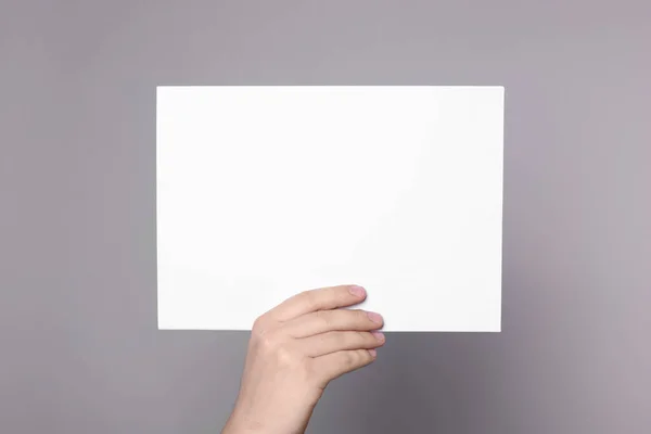 Woman Holding Sheet Paper Grey Background Closeup Mockup Design — Stok Foto