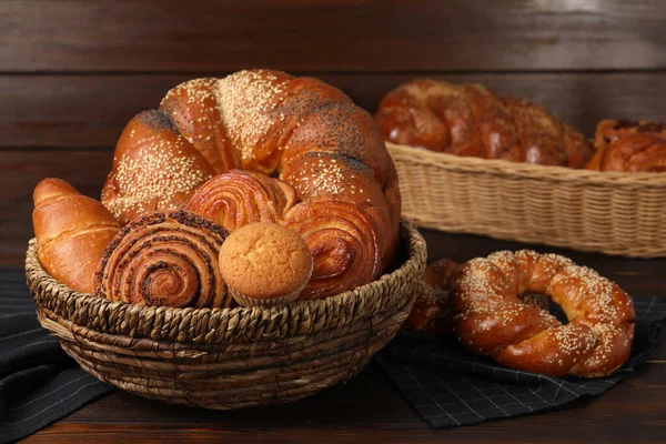 Wicker Baskets Different Tasty Freshly Baked Pastries Wooden Table — Stock Photo, Image