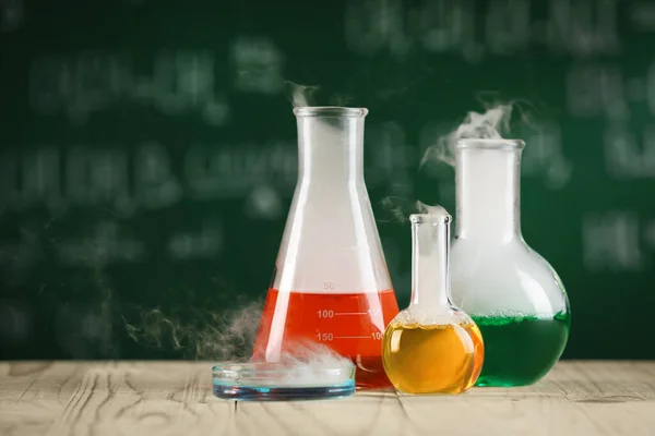 Laboratory Glassware Colorful Liquids Wooden Table Space Text Chemical Reaction — Stock Photo, Image