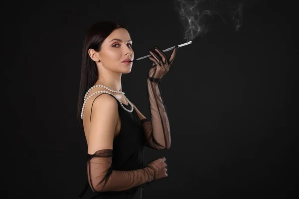 Frau Benutzt Langen Zigarettenhalter Zum Rauchen Auf Schwarzem Hintergrund Platz — Stockfoto