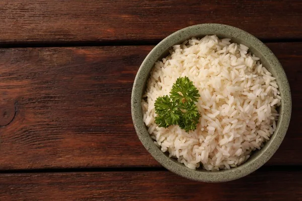 美味的米饭 碗里放着欧芹 放在木制桌子上 尽收眼底 案文的篇幅 — 图库照片
