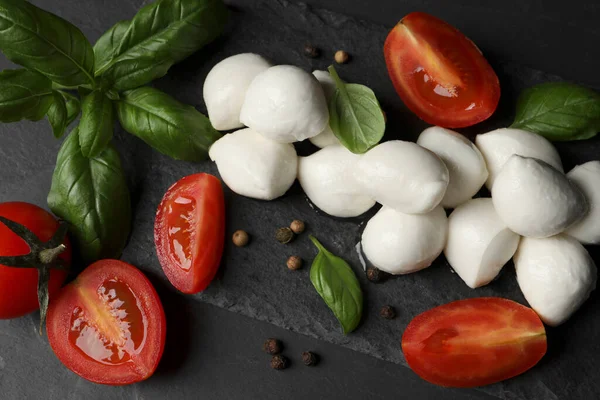 Köstliche Mozzarella Bällchen Tomaten Und Basilikumblätter Auf Schwarzem Tisch Flach — Stockfoto