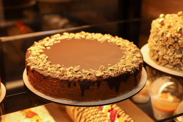 stock image Delicious wafer cake with condensed milk, chocolate and nuts on counter in bakery shop, closeup