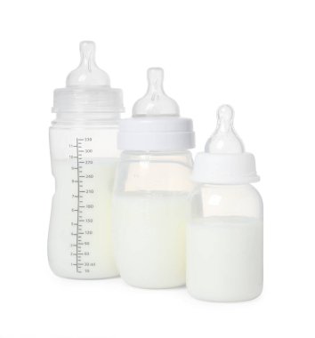 Beyaz arka planda bebek mamasıyla beslenen üç şişe.