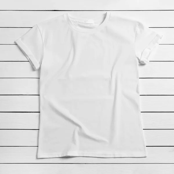 stock image Stylish t-shirt on white wooden background, top view