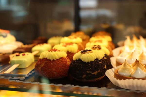 stock image Different tasty desserts on counter in bakery shop, closeup. Space for text