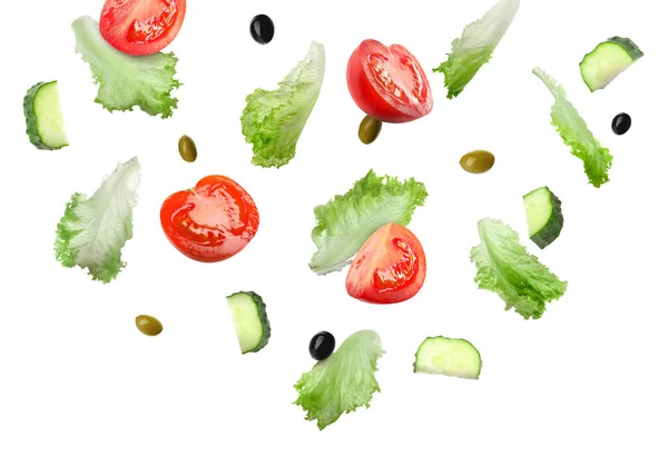 Lettuce leaves, olives, cut cucumber and tomatoes falling on white background