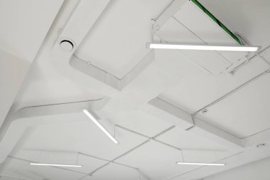 White ceiling with modern lighting in room, low angle view