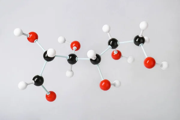 Molecule of glucose on light grey background. Chemical model